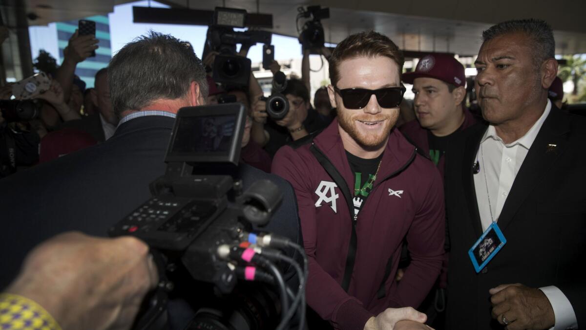 Middleweight boxer Canelo Alvarez of Mexico greets a fan as he arrives at the MGM Grand hotel-casino in Las Vegas on Tuesday. Alvarez will challenge WBC/WBA middleweight champion Gennady Golovkin in a rematch at T-Mobile Arena on Saturday.