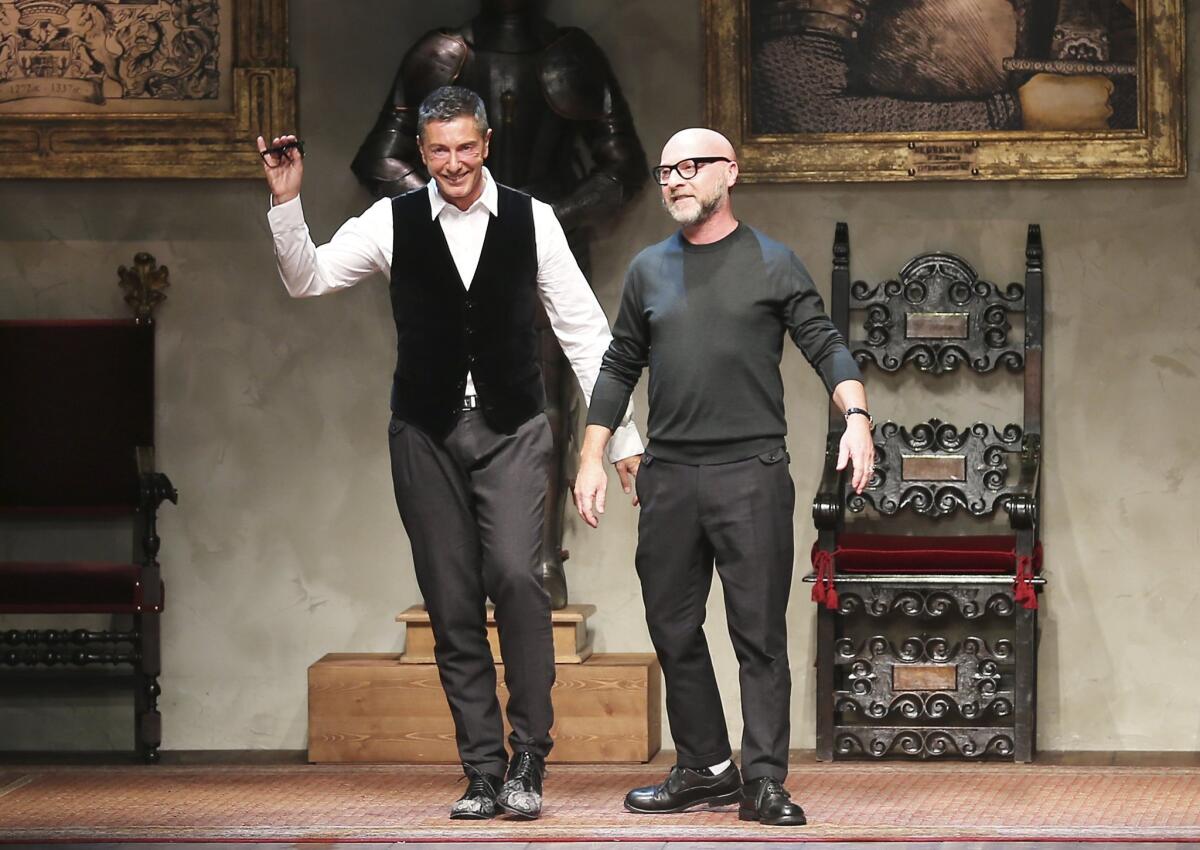 Italian fashion designers Domenico Dolce, right, and Stefano Gabbana acknowledge the applause of the audience after a show last year.