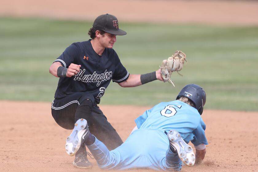 Shortstop Travis Curry (2) of Huntington Beach nails Trevor Smith (6) stealing second.