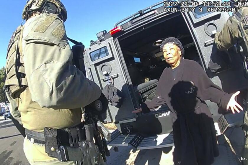 This image taken from Denver Police body camera footage provided by the American Civil Liberties Union of Colorado shows Ruby Johnson, a 78-year-old Colorado woman, surrounded by SWAT officers, Jan. 4, 2022, in Colorado. Johnson, who sued two police officers after her home was wrongly searched by a SWAT team looking for a stolen truck, won a $3.76 million jury verdict Monday, March 4, 2024, under a new Colorado law that allows people to sue police over violations of their state constitutional rights. (Denver Police Department via AP)