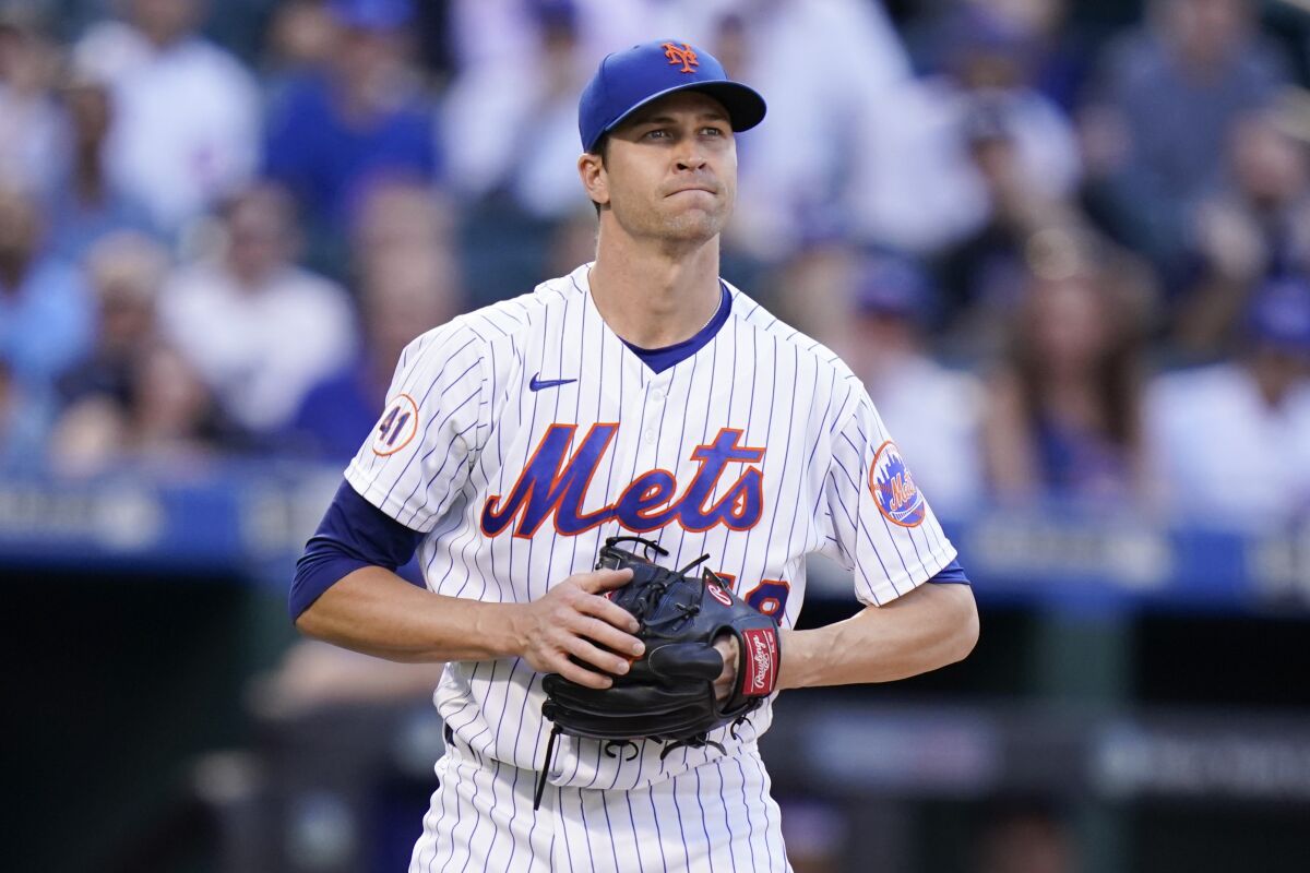 New York Mets starting pitcher Jacob deGrom reacts during the first inning of a baseball game against the Chicago Cubs Wednesday, June 16, 2021, in New York. (AP Photo/Frank Franklin II)