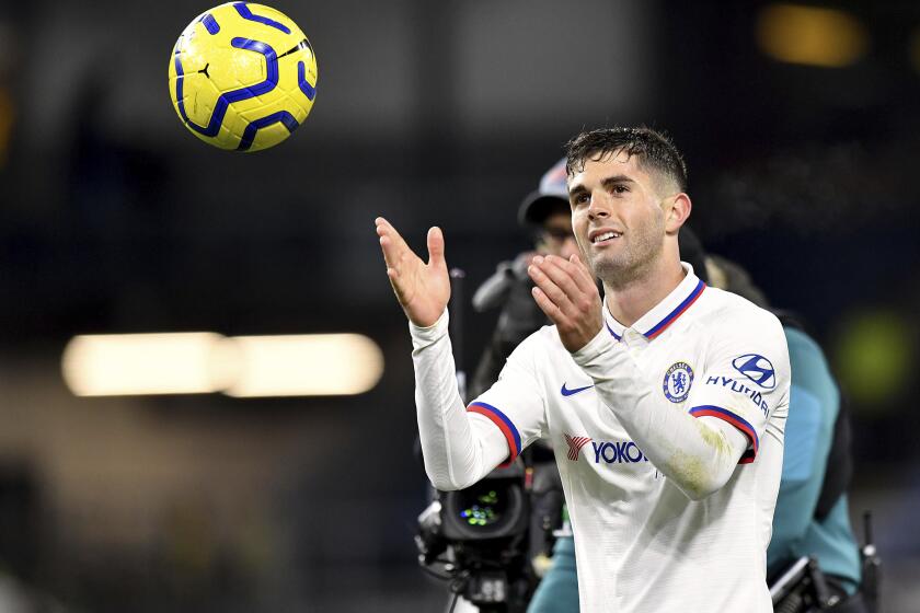 Chelsea's Christian Pulisic with the match ball after the final whistle after scoring a hat-trick during the English Premier League soccer match against Burnley at Turf Moor, Burnley, England Saturday Oct. 26, 2019. (Anthony Devlin/PA via AP)