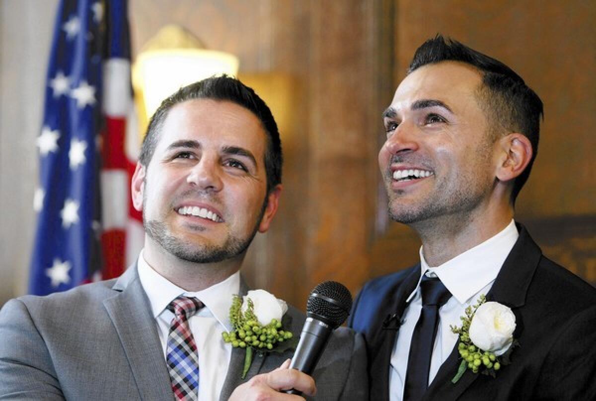 Jeff Zarillo, left, and his partner Paul Katami, right, speak to the media after their wedding ceremony officiated by outgoing Los Angeles Mayor Antonio Villaraigosa at L.A. City Hall in Los Angeles on Friday, June 28, 2013.