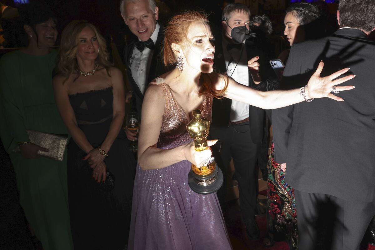 Jessica Chastain holds her winning Oscars at the Governors Ball after the 94th Academy Awards.