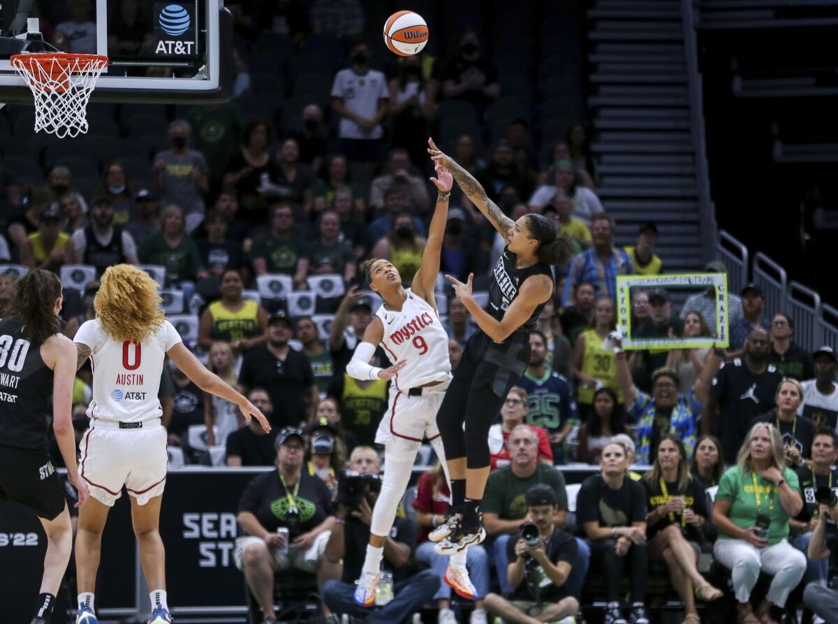 Seattle Storm forward Gabby Williams (5) shoots over Washington Mystics guard Natasha Cloud (9) during the first half of Game 1 of a WNBA basketball first-round playoff series Thursday, Aug. 18, 2022, in Seattle. (AP Photo/Lindsey Wasson)
