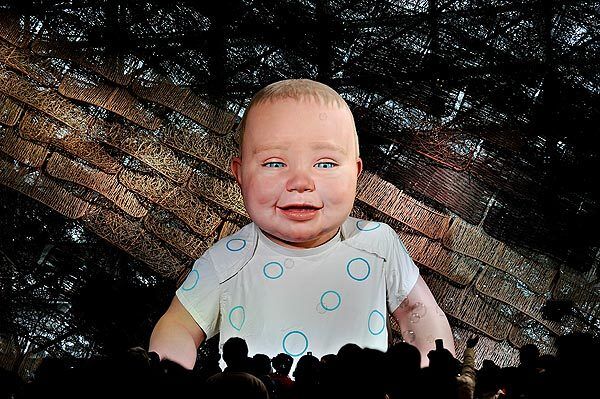 Visitors gather in front of a huge animated baby in the Spanish pavilion at the site of the World Expo 2010 in Shanghai.