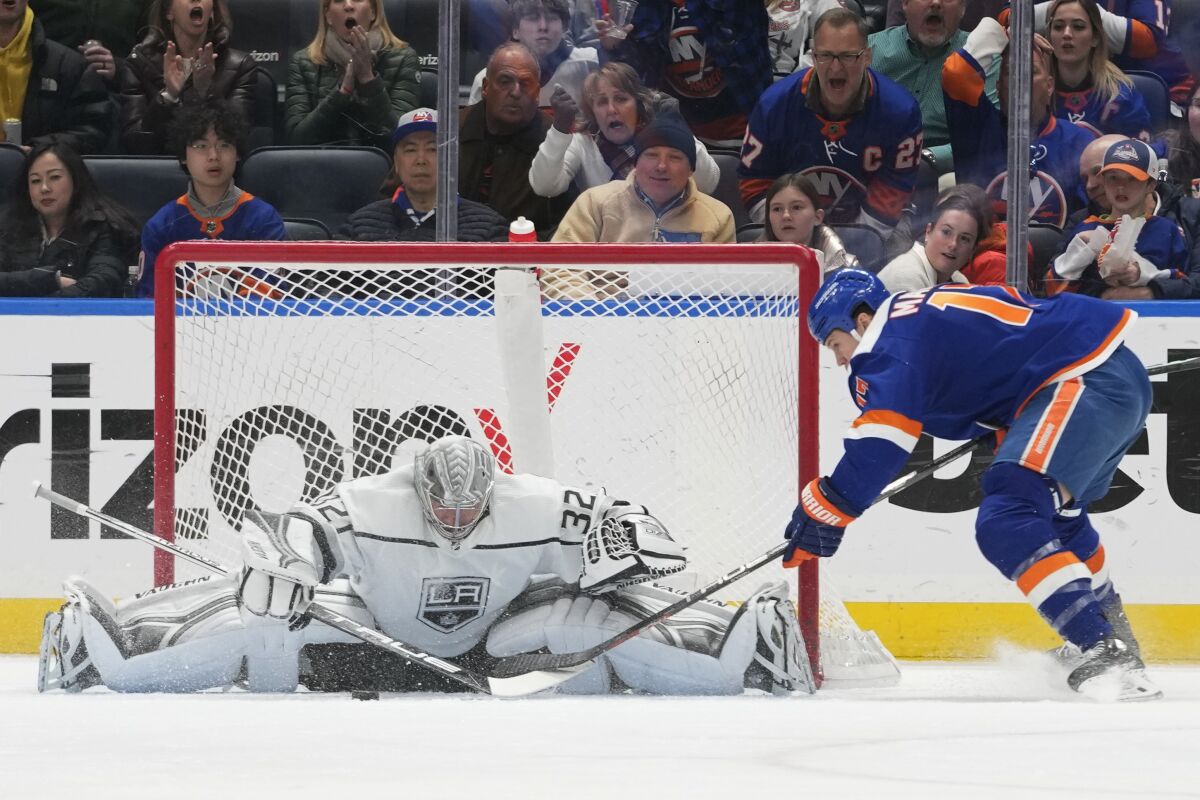 Kings goaltender Jonathan Quick stops a shot by New York Islanders forward Matt Martin.