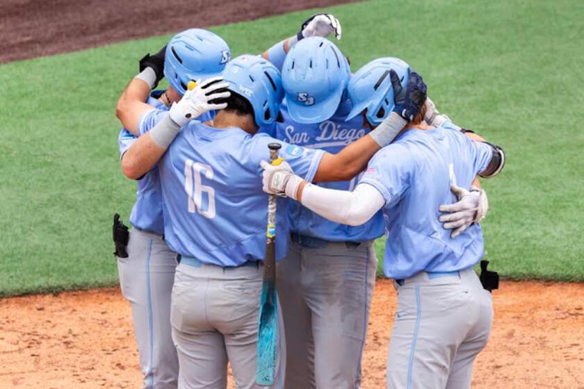 University of San Diego players gathers for a moment at home plate during game against UCSB in Santa Barbara Regional.