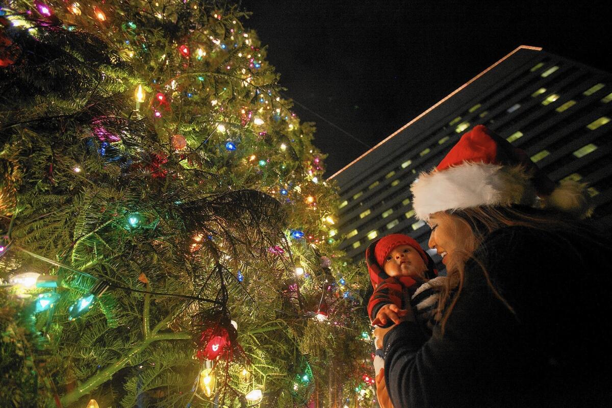 Visitors take in the sights during South Coast Plaza's tree lighting ceremony in 2013. This year's event is Thursday night next to the Westin hotel across from the Costa Mesa mall.