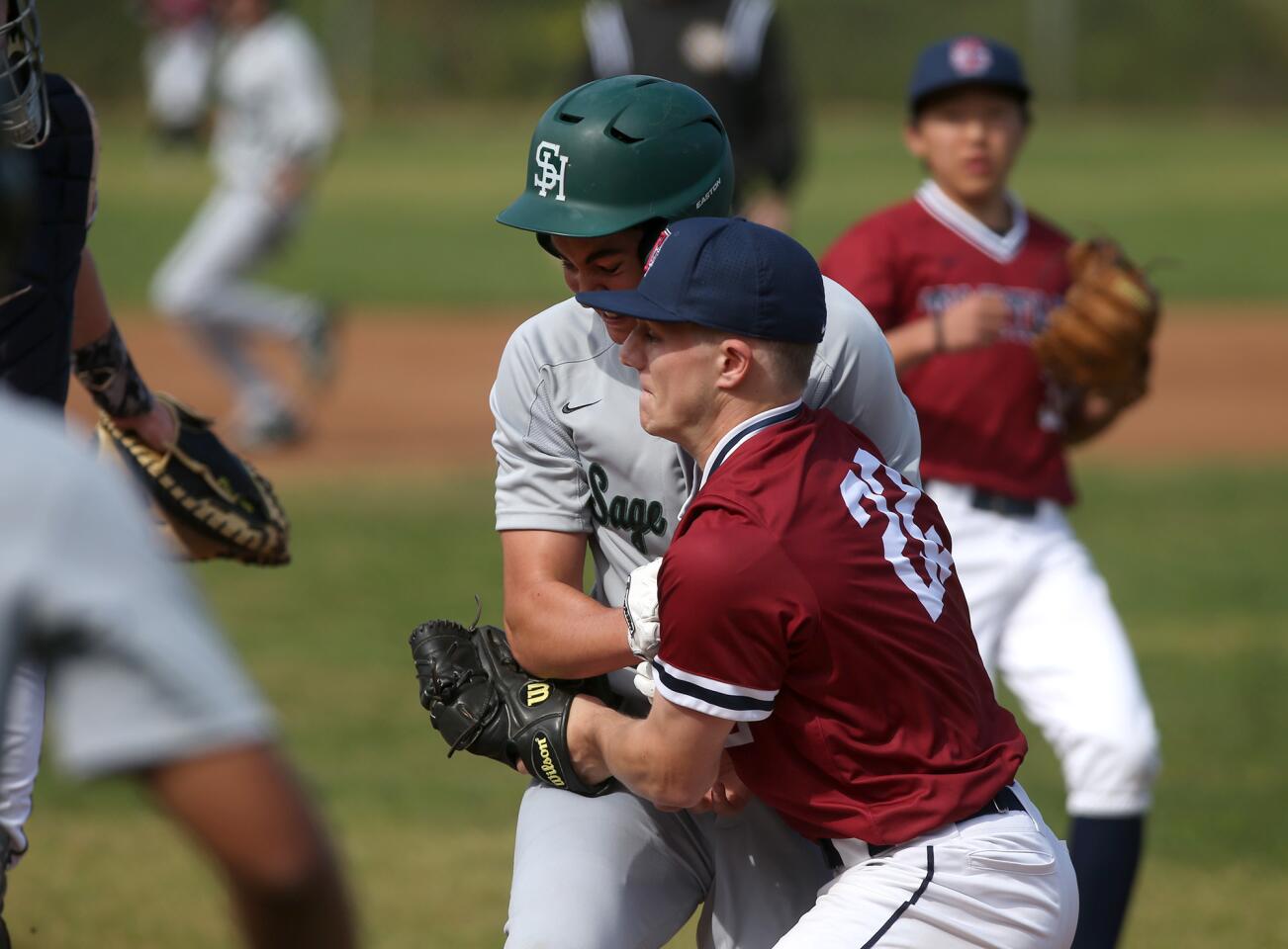 Sage Hill School's Trevor Klein collides into St. Margaret's Colin Miehe during a rundown in a San Joaquin League game at San Juan Capistrano Sports Park on Tuesday.