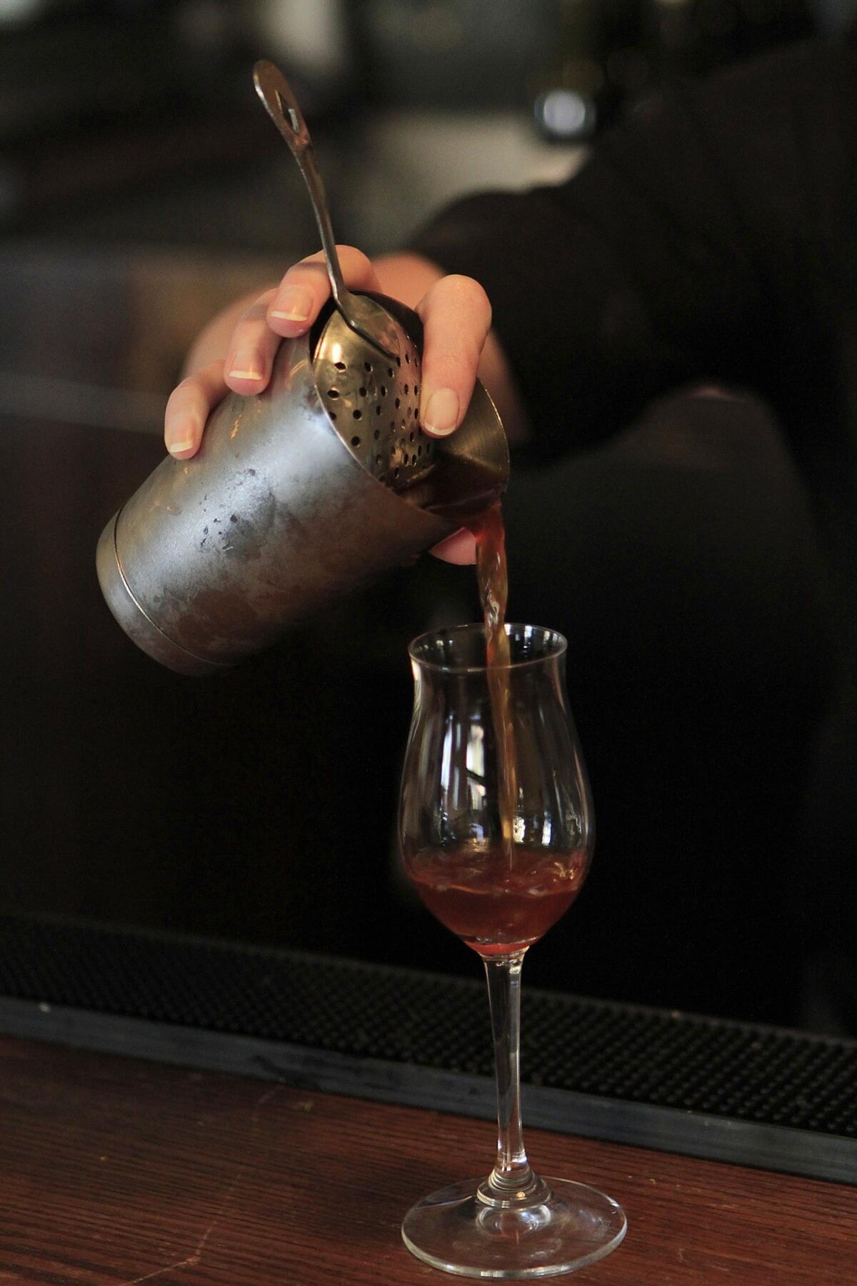 An L.A. mixologist makes a drink. Learn tricks of the trade at a workshop July 19 at the Greystone Mansion Speakeasy.