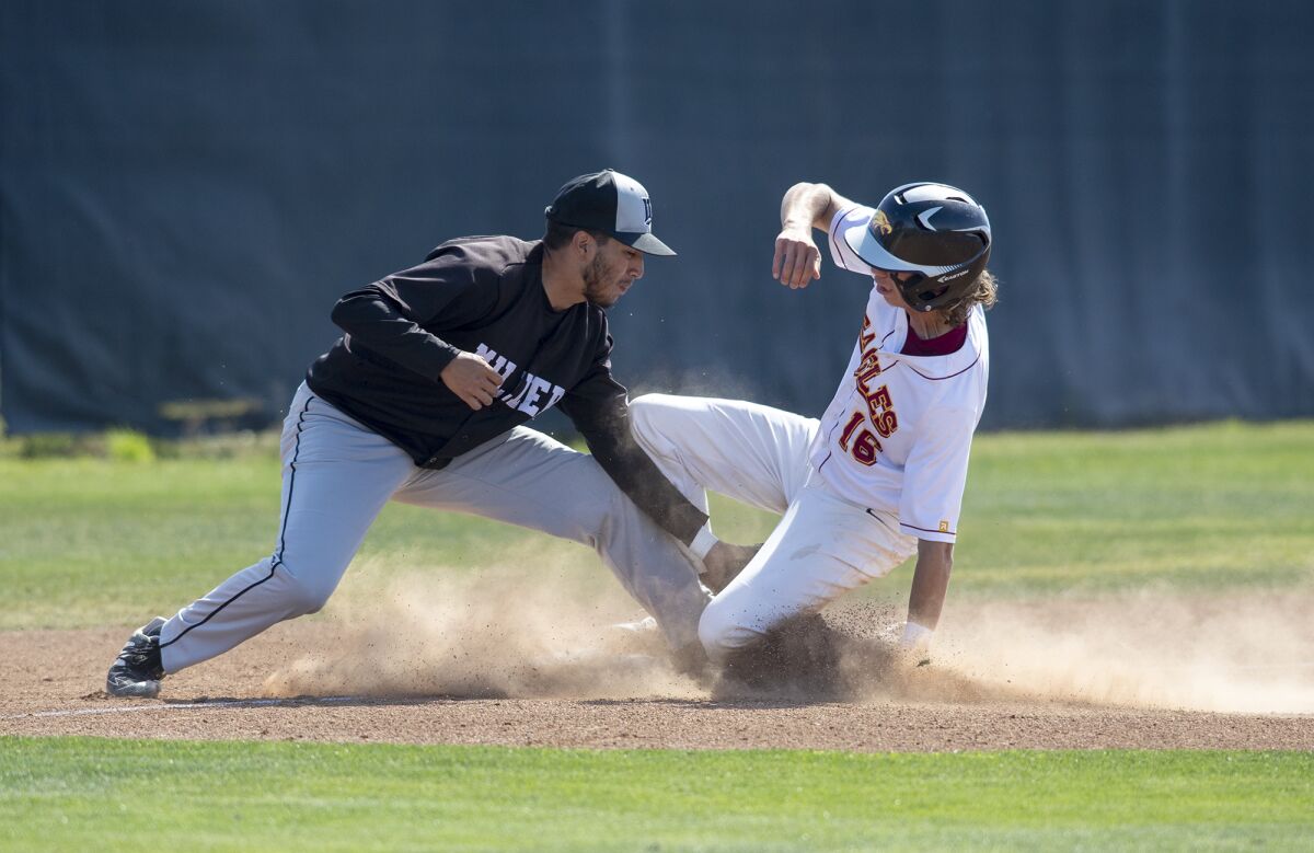 Estancia's Andrew Mits beats the tag at third from Fontana A.B. Miller's Daniel Martinez.