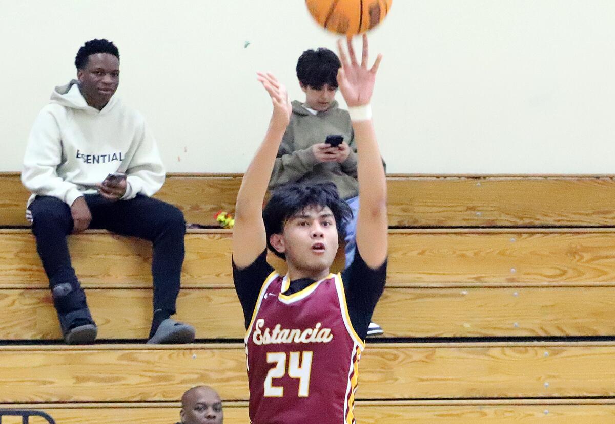 Estancia's Nik Paguirigan (24) launches a three-pointer at Chatsworth on Thursday night.
