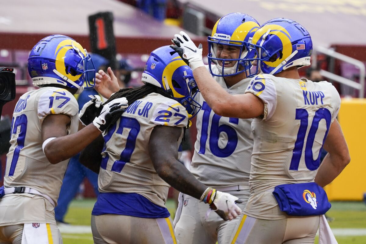 Rams' Darrell Henderson is congratulated after running for a touchdown.
