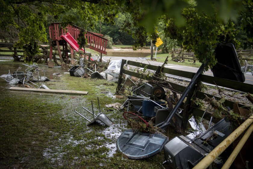 Damaged gates and debris are shown along a rural road after heavy rain in Dickson, Tenn.