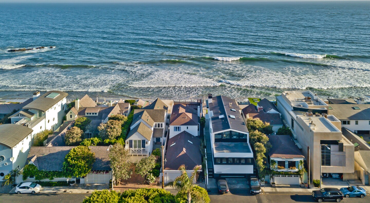 Built in 1930, the coastal home overlooks the ocean from an entertaining terrace and raised wood deck.