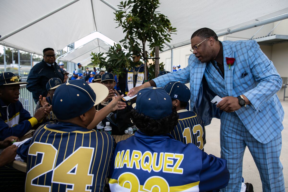 Roosevelt Williams III hands students free tickets to an upcoming Padres game