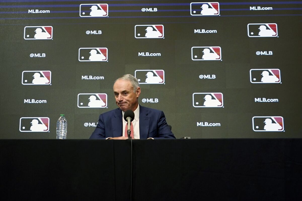 MLB Commissioner Rob Manfred pauses during a news conference Thursday in Arlington, Texas.