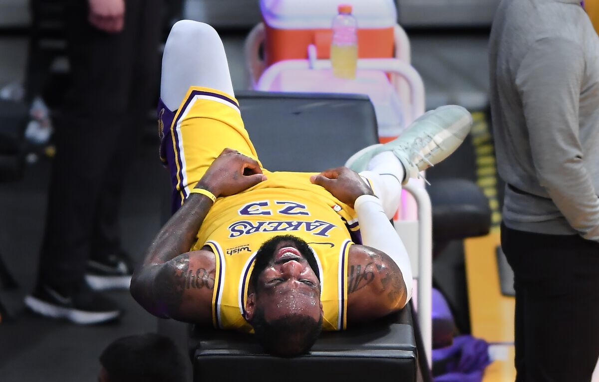 LeBron James lays on a table during a timeout in overtime against the Thunder