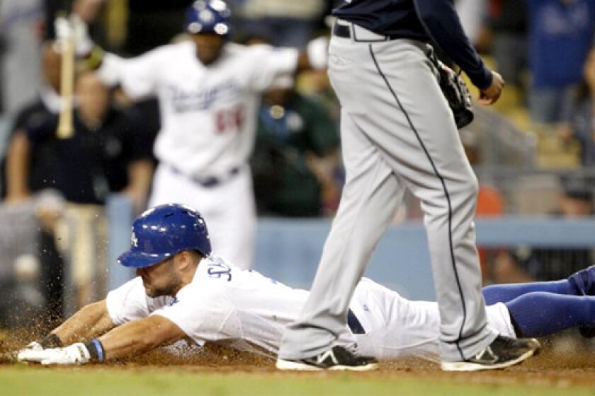 Skip Schumaker slides head-first into home plate on a wild pitch, giving the Dodgers a 2-1 victory in the 10th inning against the Atlanta Braves on Friday.