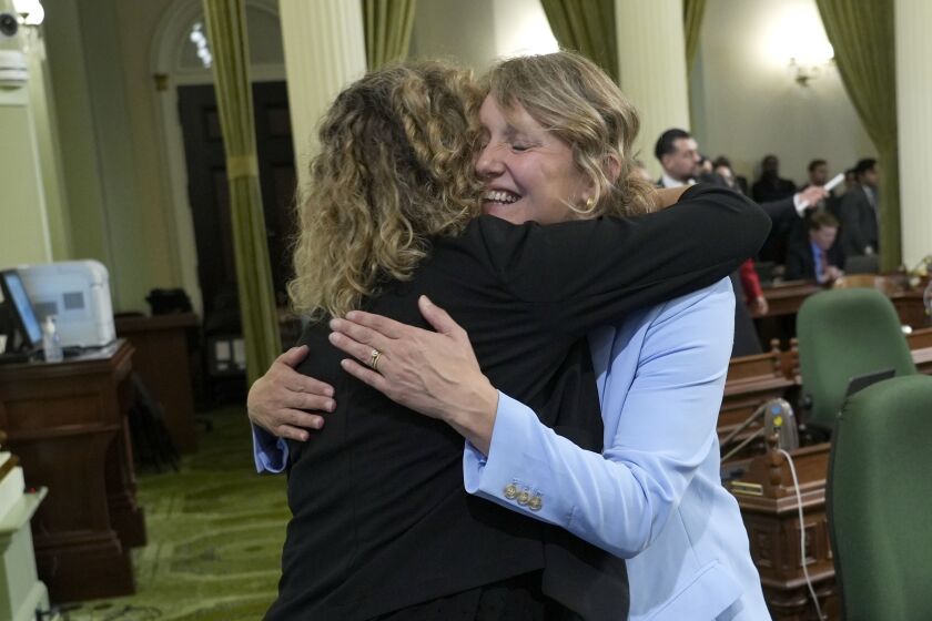 Assemblywoman Pilar Schiavo, D-San Fernando Valley, left, congratulates Assemblywoman Buffy Wicks, D-Oakland, after Wicks' measure that would force Big Tech companies to pay media outlets for using their news content, was approved by the Assembly at the Capitol in Sacramento, Calif., Thursday, June 1, 2023. The measure now goes to the Senate for consideration. (AP Photo/Rich Pedroncelli)