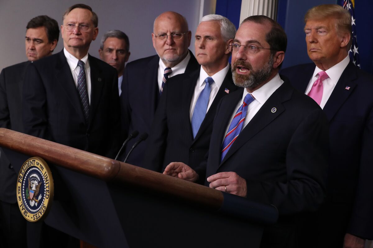 Alex Azar, secretary of Health and Human Services, right, with public health officials in the White House briefing room Feb. 26, said, “We can expect to see more cases in the United States.”