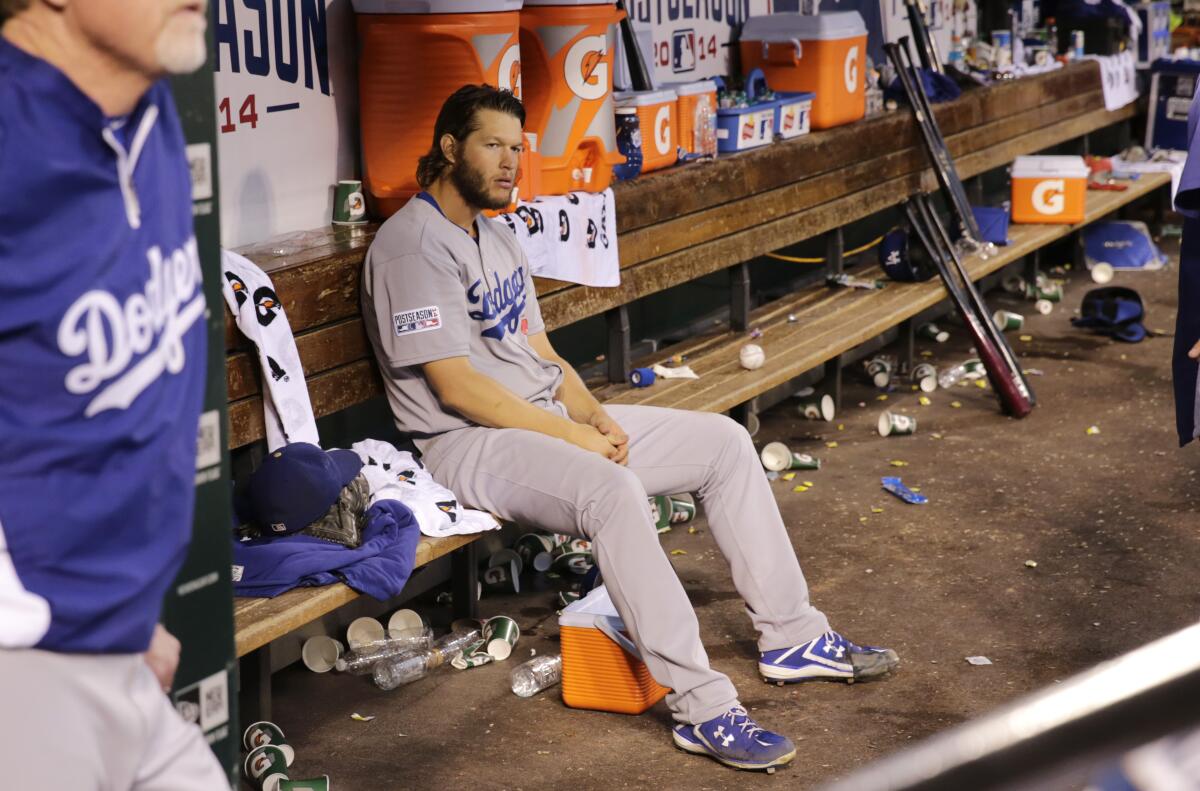 Dodgers pitcher Clayton Kershaw sits in the dugout after being removed in the seventh inning during Game 4 of the 2014 NLDS.