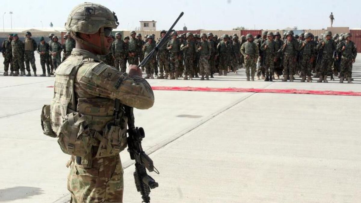 A member of the U.S. military stands guard in July 2016 during a graduation ceremony for Afghan troops in Lashkar Gah, capital of Afghanistan's Helmand province.