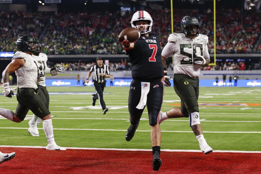 Utah quarterback Cameron Rising scores on a two-point conversion during a win over Oregon.
