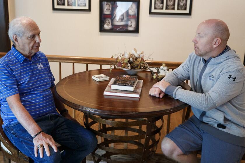 Hep Cronin, left, speaks with his son, UCLA basketball coach Mick Cronin in Mick's home In Cincinnati, Ohio, Tuesday, May 28, 2019.