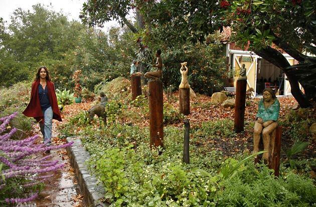 Ojai artist Sandy Wolk shows off her sculptures outside her home studio.