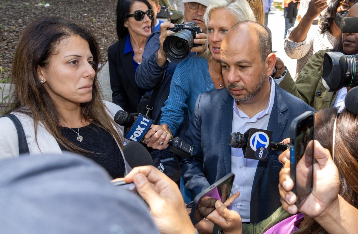 Nancy Iskander and her husband, Karim, talk with media.