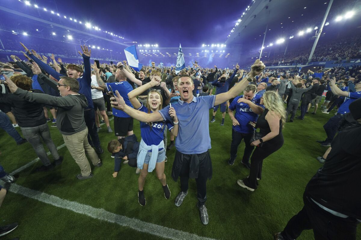 Everton fans celebrate the victory against Christal Palace during the English Premier League soccer match between Everton and Crystal Palace at Goodison Park in Liverpool, England, Thursday, May 19, 2022. (AP Photo/Jon Super)