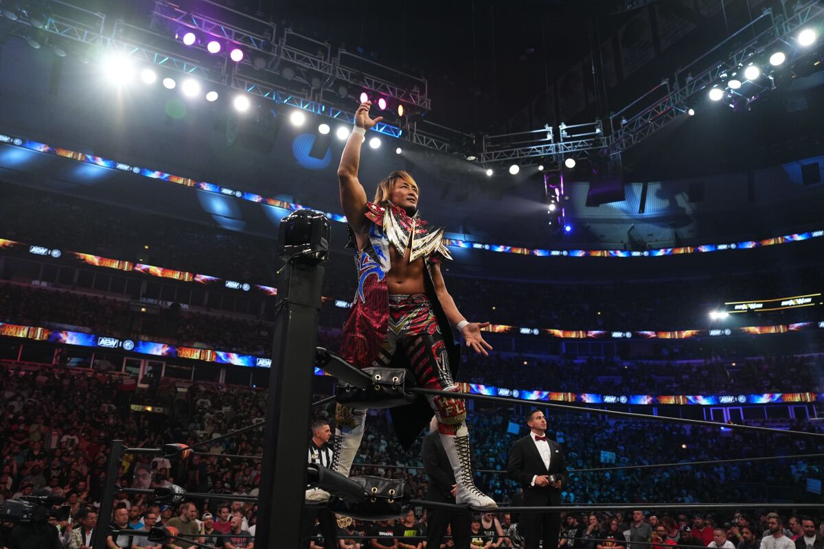 A wrestler poses for a photo in the ring.