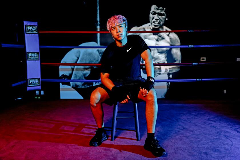 LOS ANGELES, CA - JANUARY 14: Michael Le, 21, of Los Angeles, a TikTok influencer who is training for his second boxing match at Ricky's Boxing Gym on Friday, Jan. 14, 2022 in Los Angeles, CA. Le has more than 51 million followers on TikTok and is known for his dance videos. He is training with Ricky Quiles, 51, a retired professional lightweight boxer. (Gary Coronado / Los Angeles Times)