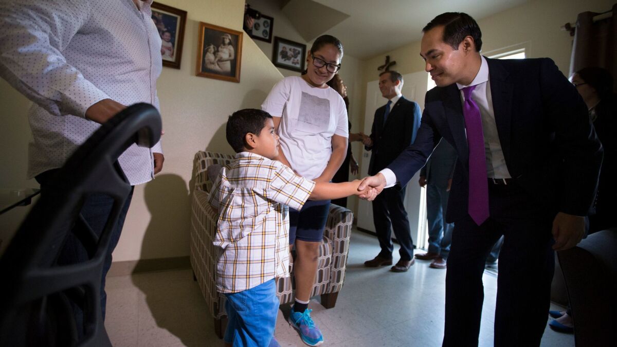 HUD Secretary Julian Castro greets Anthony Mares, 4, in the boy's Estrada Courts home in Boyle Heights in September. A new program will bring free books to residents of public housing like Estrada Courts.