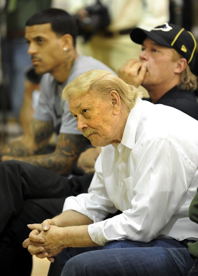 Lakers owner Jerry Buss and son Jim listen along with player Matt Barnes to new head coach Mike Brown during a news conference in El Segundo.