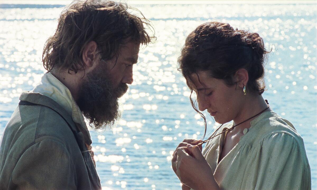 A man and a woman examine the necklace she is wearing in the movie “The Tale of King Crab.”
