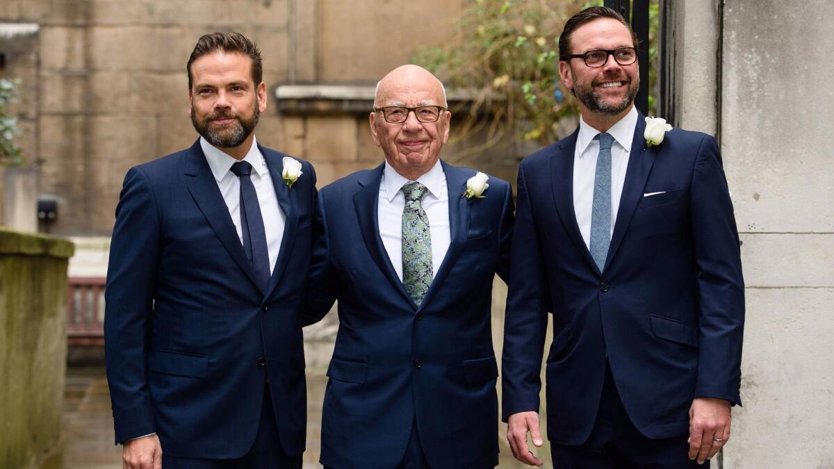 Media mogul Rupert Murdoch, center, flanked by his sons Lachlan, left, and James in London in 2016. The Murdochs have been in talks to sell parts of their media company, 21st Century Fox, to Disney, sources say.