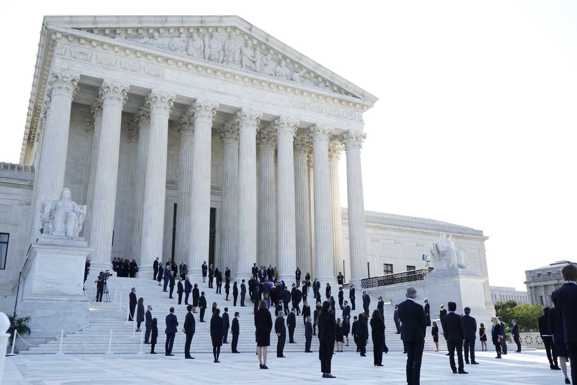 The flag-draped casket of Justice Ruth Bader Ginsburg is carried up the steps of the Supreme Court in Washington, D.C.