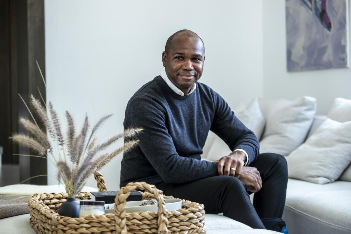 Darnell Strom sits on a couch at his home in Beverly Hills.