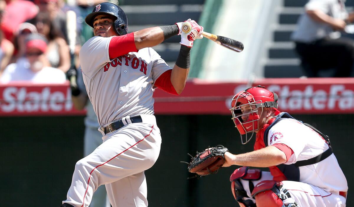 Red Sox left fielder Yoenis Cedspedes follows through on his three-run home run against the Angels in the eighth inning Sunday afternoon in Anaheim.