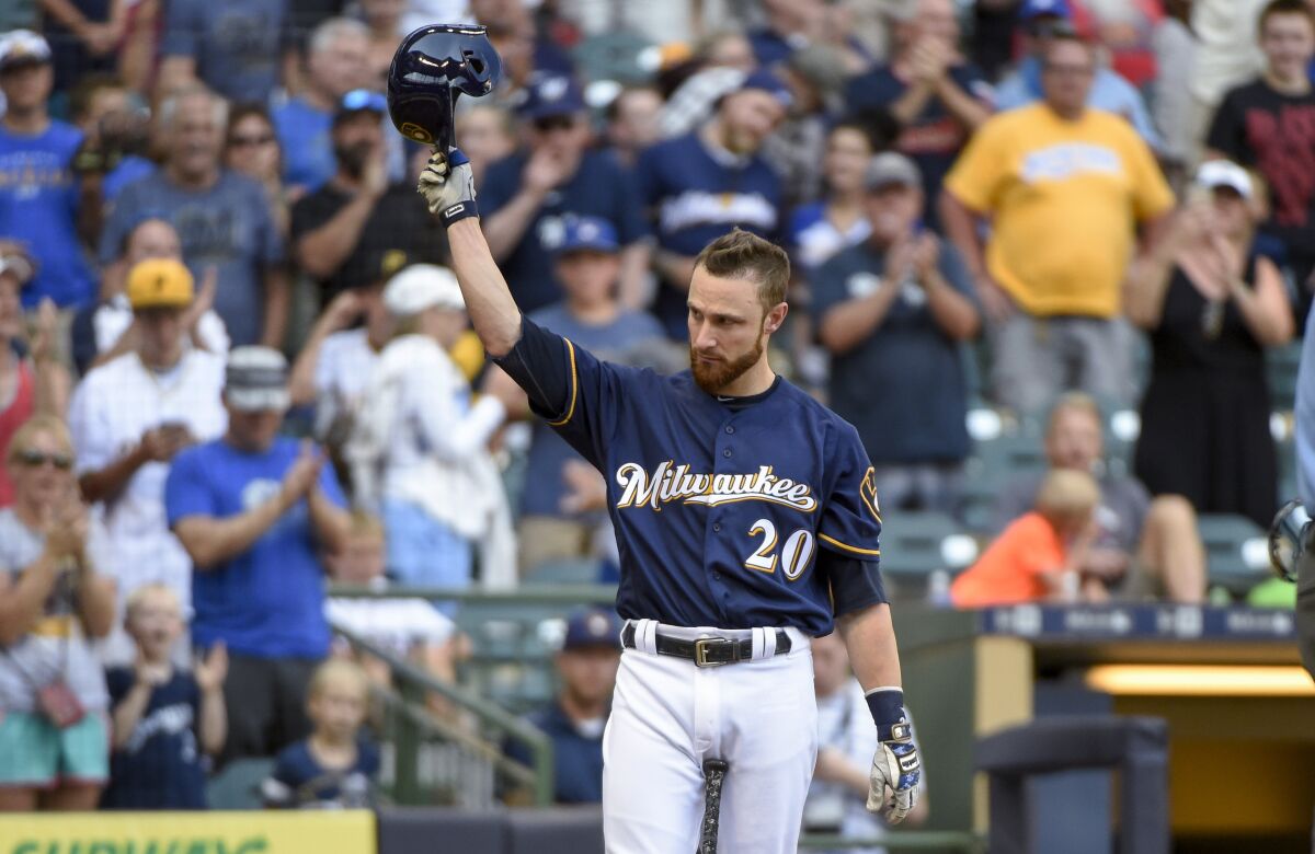 FILE - Milwaukee Brewers' Jonathan Lucroy tips his cap after getting a standing ovation from fans while pinch-hitting during the eighth inning of a baseball game against the Pittsburgh Pirates on July 31, 2016, in Milwaukee. Lucroy says he is retiring, more than a year after playing his last major league game. The Brewers said Tuesday, Aug. 2, 2022, that Lucroy will be inducted into the team’s wall of honor on Saturday. Lucroy played for the Brewers from 2010-16 and was an All-Star in 2014 and 2016 .(AP Photo/Benny Sieu, File)