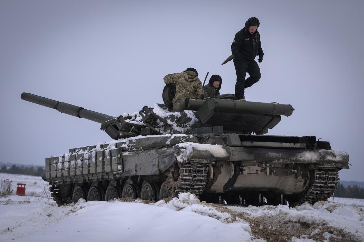 FILE - Ukrainian soldiers practice on a tank during military training in Ukraine Wednesday, Dec. 6, 2023. The world has entered an era of increasing instability as countries around the globe boost military spending in response to Russia’s invasion of Ukraine, the Hamas attack on Israel and China’s growing assertiveness in the South China Sea. That’s the conclusion of a new report from the International Institute for Strategic Studies released on Tuesday Feb. 13, 2024. (AP Photo/Efrem Lukatsky, File)