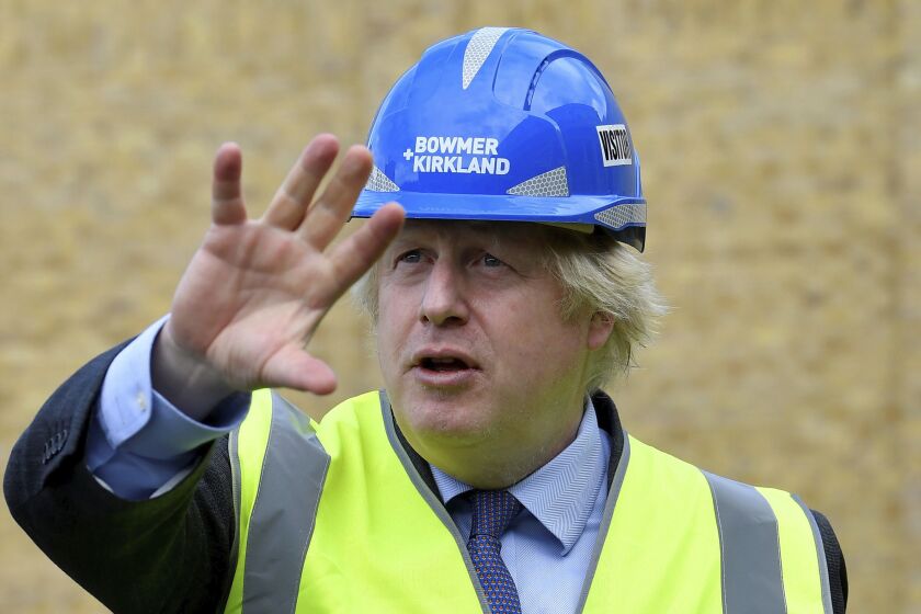 Britain's Prime Minister Boris Johnson visits the construction site of Ealing Fields High School in west London, Monday June 29, 2020. (Toby Melville/Pool via AP)
