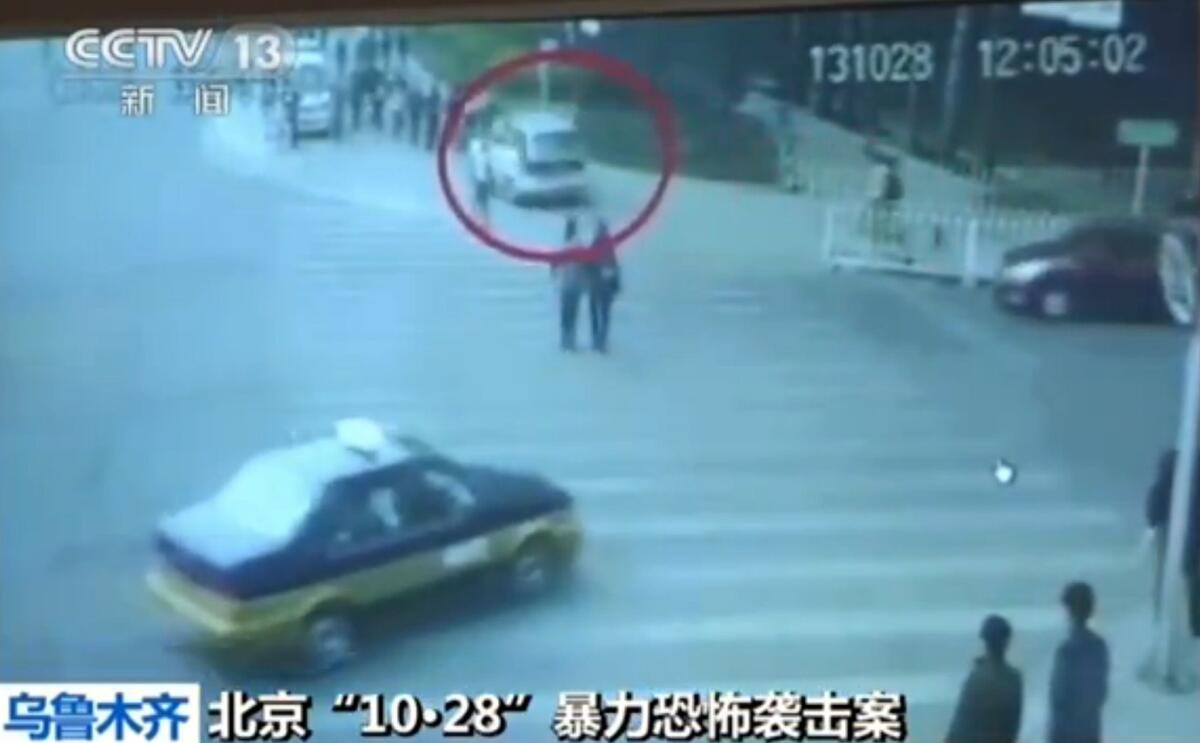 A screen grab taken from state broadcaster China Central Television (CCTV) shows security-camera images of a white vehicle as it plows into people during an October 2013 attack in Beijing's Tiananmen Square.