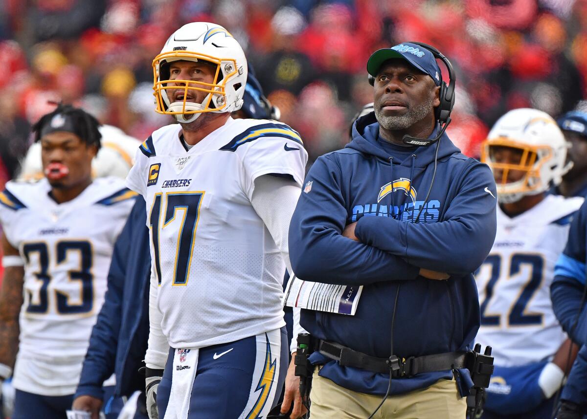 Chargers coach Anthony Lynn and quarterback Philip Rivers watch a replay during a loss to the Chiefs on Dec. 29.