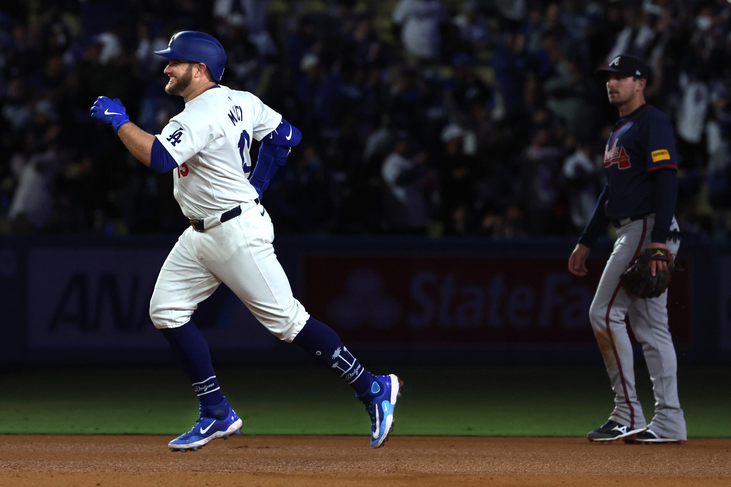 Max Muncy rounds the bases after hitting his third home run in the Dodgers' 11-2 win over the Atlanta Braves.