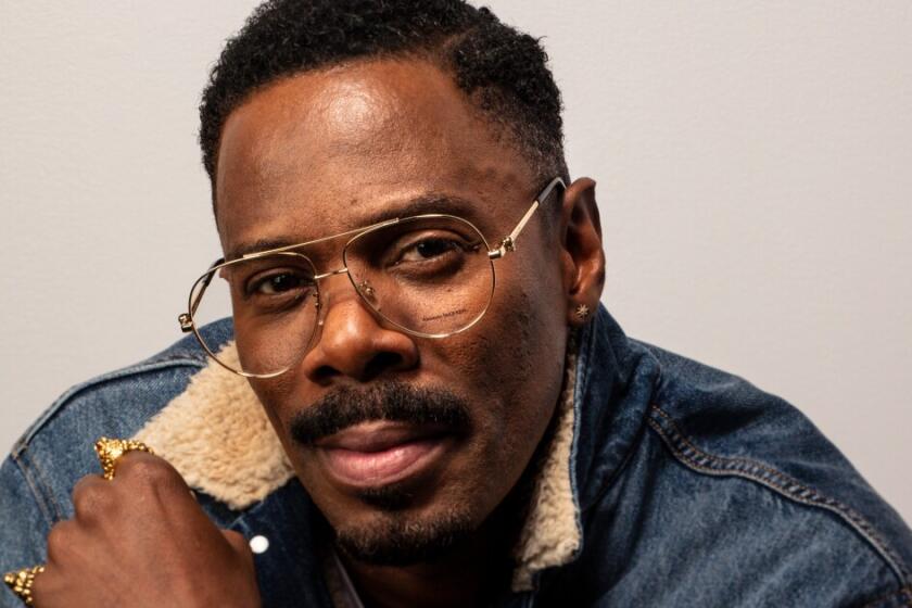 Actor Colman Domingo wearing glasses and a denim jacket