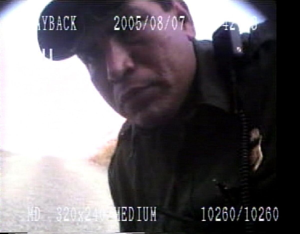 An image from a video of Border Patrol agent Fidel Villarreal shows him apparently finding and then disconnecting a camera hidden on the bumper of his vehicle.